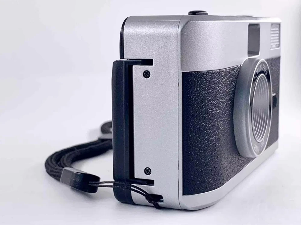 manual wind reusable film camera - camera with a wrist strap attached